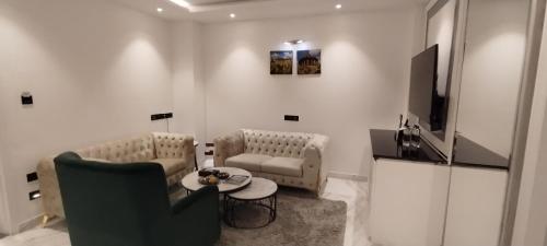 a living room with a couch and a table and a tv at Amanora The Fern Hotels & Club in Pune