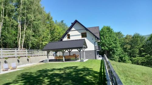 a house with a gazebo in the yard at Dom Camelowo Willa in Brenna