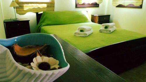 a bedroom with a bed with a flower in a basket at Pension Anastasia in Ammouliani