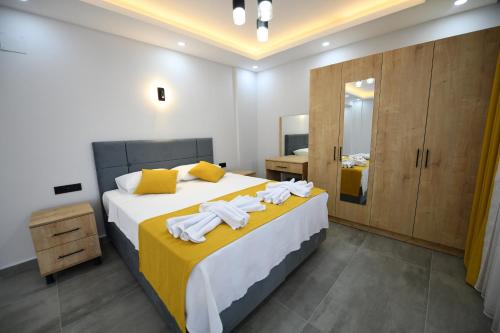a bedroom with a large bed with towels on it at Villa Bağ Tepesi in Fethiye