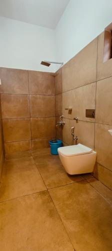 a bathroom with a tub and a toilet in it at Grandstaykannur in Kannur