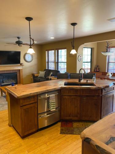 a kitchen with a large island in a living room at Ski+Golf+Fishing Flagstaff Kachina Cabin! in Mountainaire