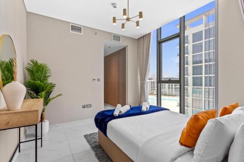 a bedroom with a bed and a large window at Premium 1-BR with Exquisite Layout in District One in Dubai