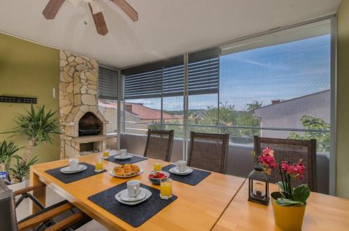 a dining room with a table and a fireplace at Apartment Oliver in Soline