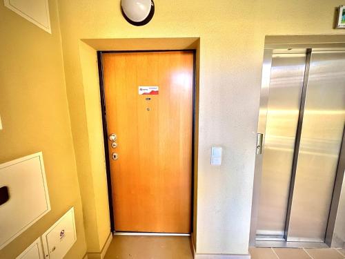 a wooden door in a hallway with a clock at Vilamoura Prestige 2 With Pool by Homing in Vilamoura