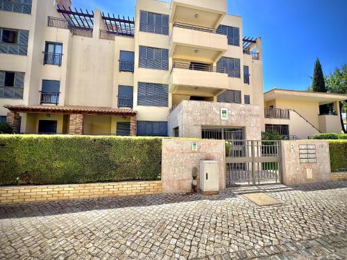 a large building with a gate in front of it at Vilamoura Prestige 2 With Pool by Homing in Vilamoura