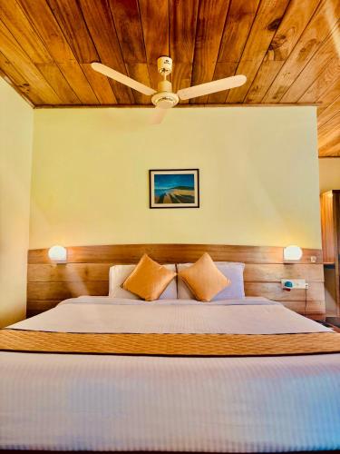 a bedroom with a bed with a wooden ceiling at PRISTINE BEACH RESORT in Diglipur
