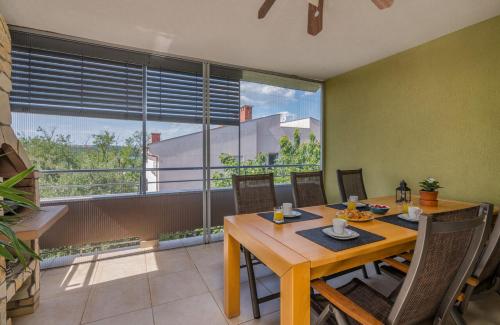 a dining room with a table and a large window at Apartment Oliver in Soline
