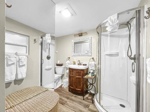 a bathroom with a shower and a sink and a toilet at Family Tides Steps to beach and bay in Bradenton Beach