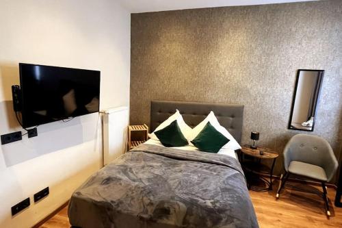 a bedroom with a bed and a flat screen tv at Relax in Duisburg