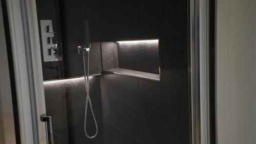 a shower in a bathroom with a mirror at Diana's luxury guest house in Padova