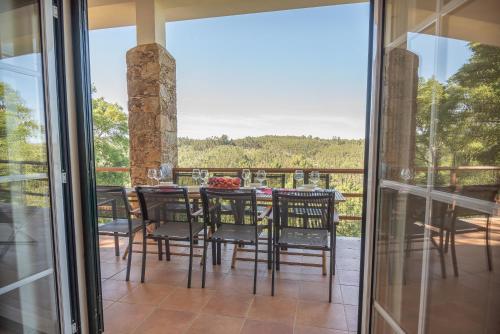 a dining room with a table and chairs on a balcony at The Art House in Tomar