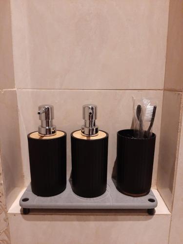 two bottles of toothbrushes on a shelf in a bathroom at Griya Endika Syariah in Yogyakarta