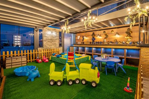 a room with a toy train on the grass at Paradiso Dreams Hotel in Nesebar