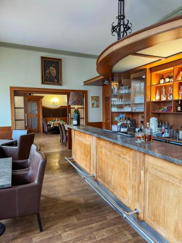 a bar in a restaurant with chairs and tables at Hotel Růžek in Hranice