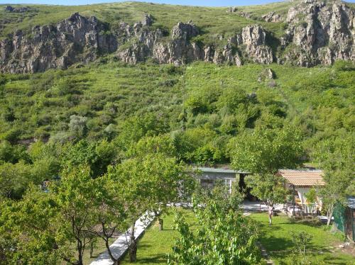 a house in the middle of a mountain at ТИФАНИ - дом с бассейном у речки in Bjni