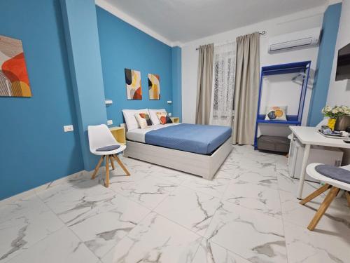 a blue bedroom with a king sized bed and blue walls at KeyRooms in La Spezia