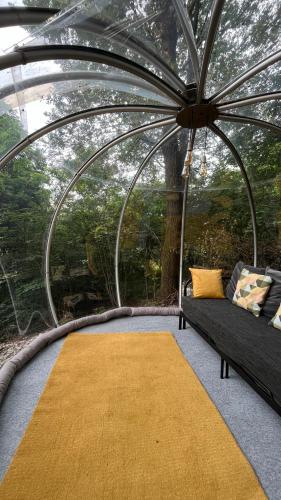 a gazebo with a couch and a yellow rug at ForRest Boutique Cabin in Dunabogdány