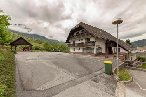 an empty parking lot in front of a building at Apartments Bor in Bohinj
