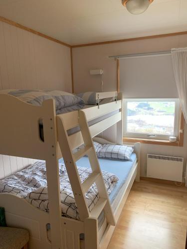 a bedroom with two bunk beds and a window at Voss Resort self-service apartments in Skulestadmo
