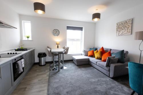 a living room with a couch and a table at Victoria Apartments in Skegness