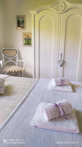 a white bed with two pillows on top of it at Kuća za odmor Zdravac in Kragujevac
