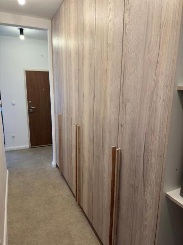 a large wooden cabinet in a room with a door at Nonna Marija in Kotor
