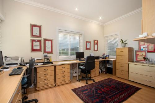 an office with two desks and two chairs at 138 Marine Beachfront Guesthouse in Hermanus