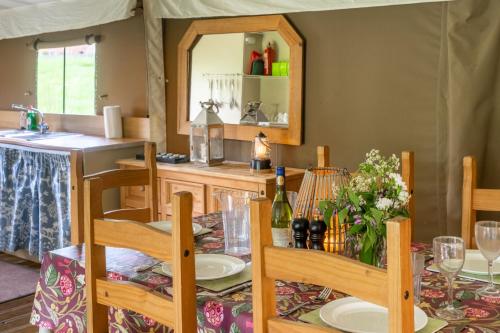a dining room with a table and a mirror at Teal - Exton Park in Exton