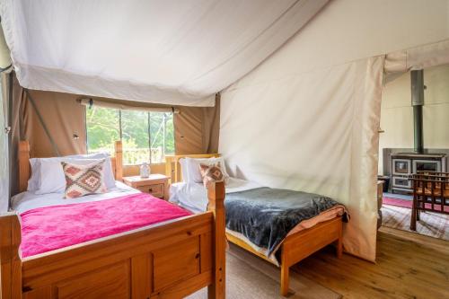 a bedroom with a canopy bed and a fireplace at Teal - Exton Park in Exton