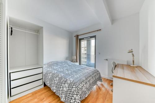 ein weißes Schlafzimmer mit einem Bett und einem Fenster in der Unterkunft GuestReady - Charming getaway with a terrace in Lyon