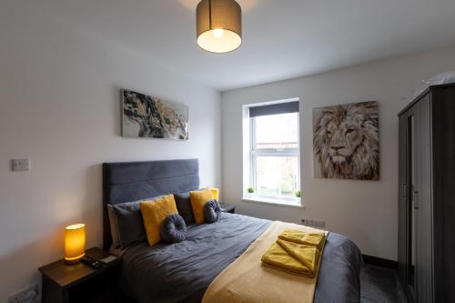 a bedroom with a bed with a lion picture on the wall at Victoria Apartments in Skegness
