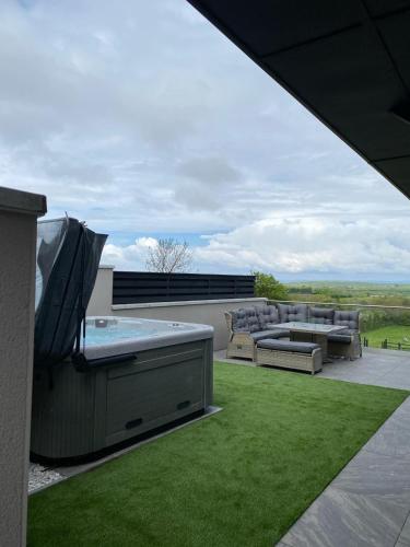 a patio with a hot tub and furniture on a roof at Channel View in Weston-super-Mare