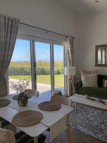 a living room with a table and a large window at Channel View in Weston-super-Mare