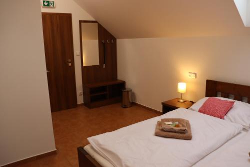 a bedroom with a bed with a tray on it at Pension Florián in Pavlov