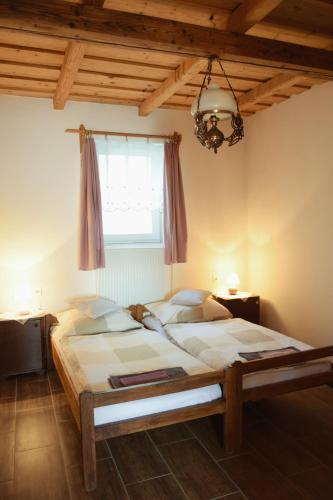 a bedroom with a large bed and a window at Anna Apartman in Maroslele