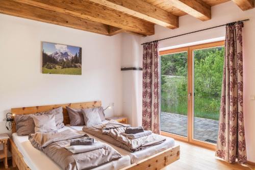 a bedroom with a bed and a large window at Mountainlodge in Leutasch