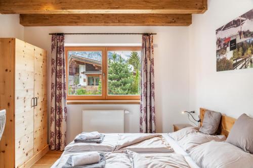 a bedroom with a bed and a window at Mountainlodge in Leutasch