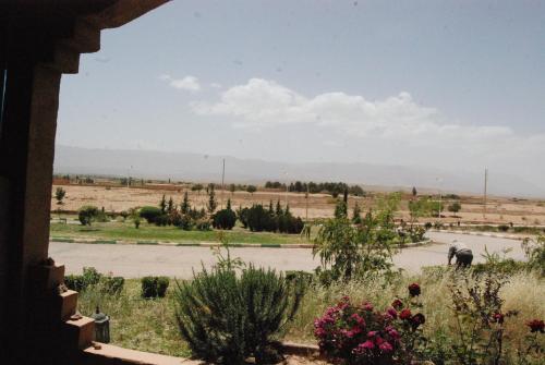 a view from a window of a field with an elephant at Hotel Taddart in Midelt