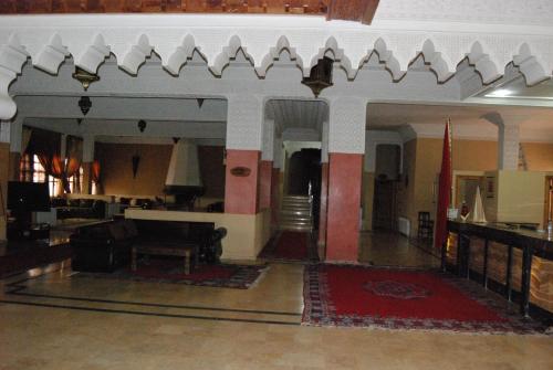 a living room with a couch and a table at Hotel Taddart in Midelt