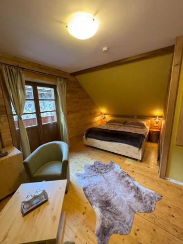 a bedroom with a bed and a wooden floor at Chata Piecky in Hrabušice