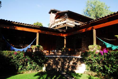 a house with a porch with at Casa Nora Malinalco - Entire Estate With pool in Malinalco