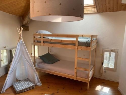 a room with two bunk beds and a hammock at Magnanerie en plein cœur d'un village in Collias