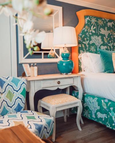 a bedroom with a bed and a desk with a lamp at The Swan Hotel and Spa in Newby Bridge