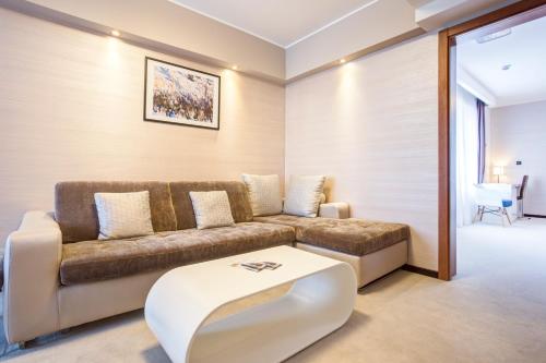 a living room with a couch and a coffee table at Hotel Heritage in Belgrade