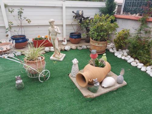 a garden with figurines of chickens and a dog on the grass at beautiful apartment with garden in Amélie-les-Bains-Palalda