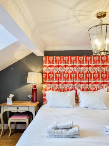 a bedroom with a large white bed and a desk at The Swan Hotel and Spa in Newby Bridge