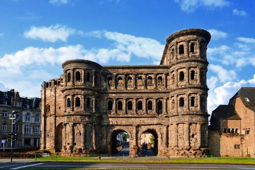 a large stone building with an arch in a city at Ferienhaus mit Whirlpool und Sauna in Bernkastel-Kues