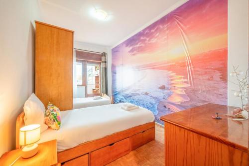 a bedroom with a bed and a painting on the wall at GuestReady - Sea Breeze in Costa da Caparica in Lisbon