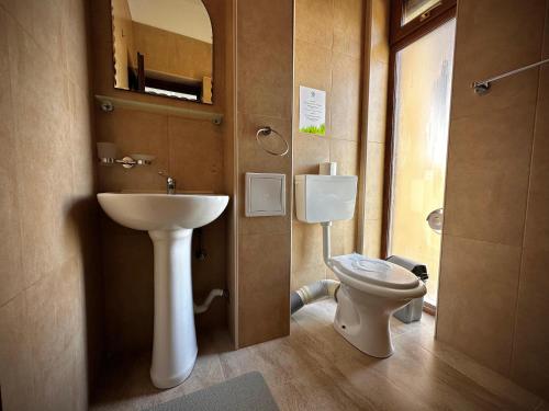 a bathroom with a sink and a toilet at VILA FLORIDA & MIAMI in Eforie Nord